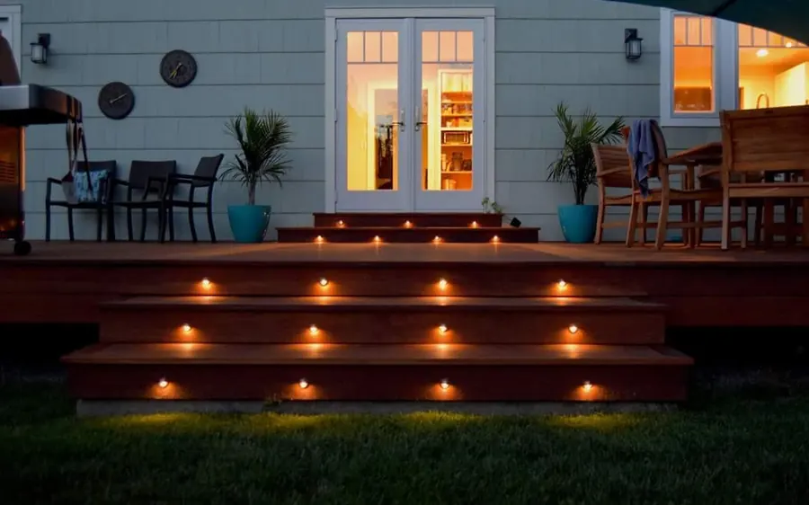 Ipe hardwood deck with lit steps at dusk behind a Monmouth County, NJ home